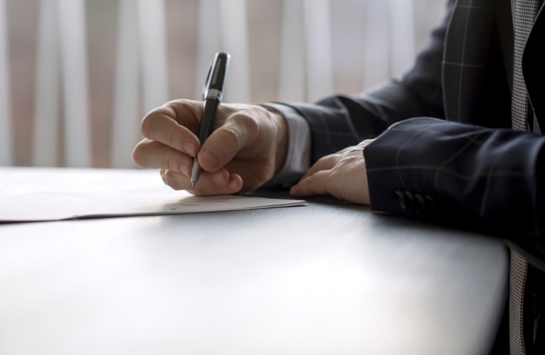 Man is signing documents