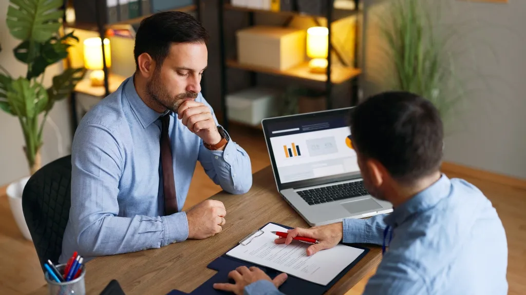 Businesspeople analyzing a contract during financial negotiations in an office